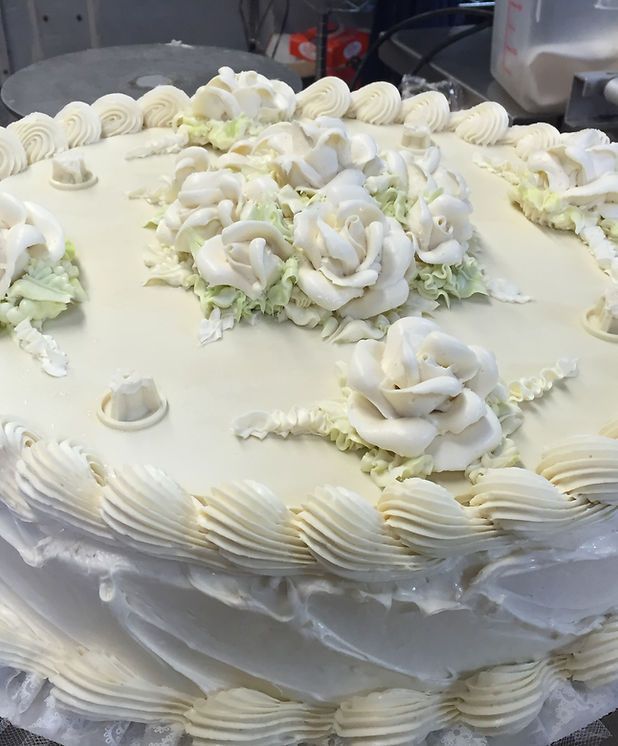 A cake with white frosting and flowers on it