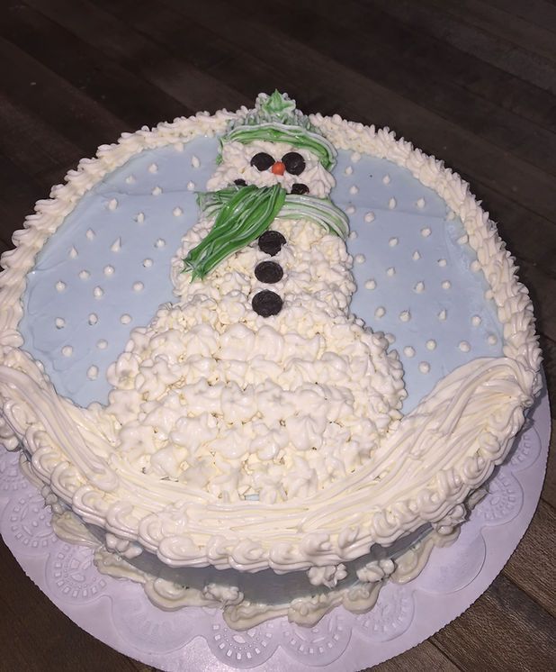 A cake with a snowman on top of it