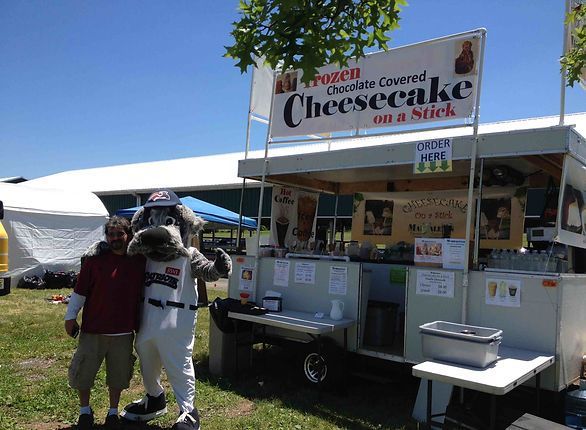 Man and mascot pose near a