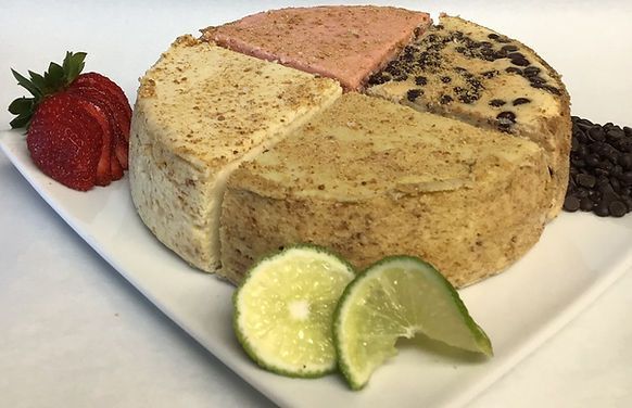A white plate topped with a cake , strawberries , limes and chocolate chips.