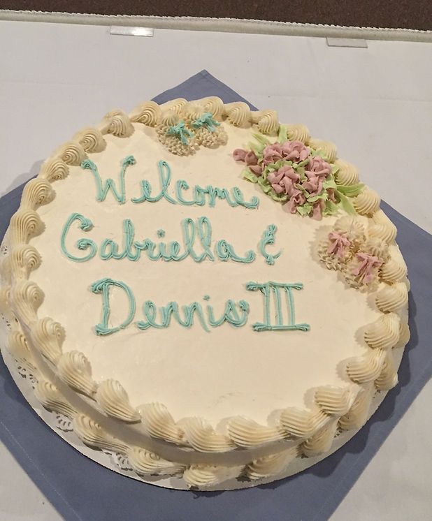 A cake that says welcome gabriella dennis iii on it