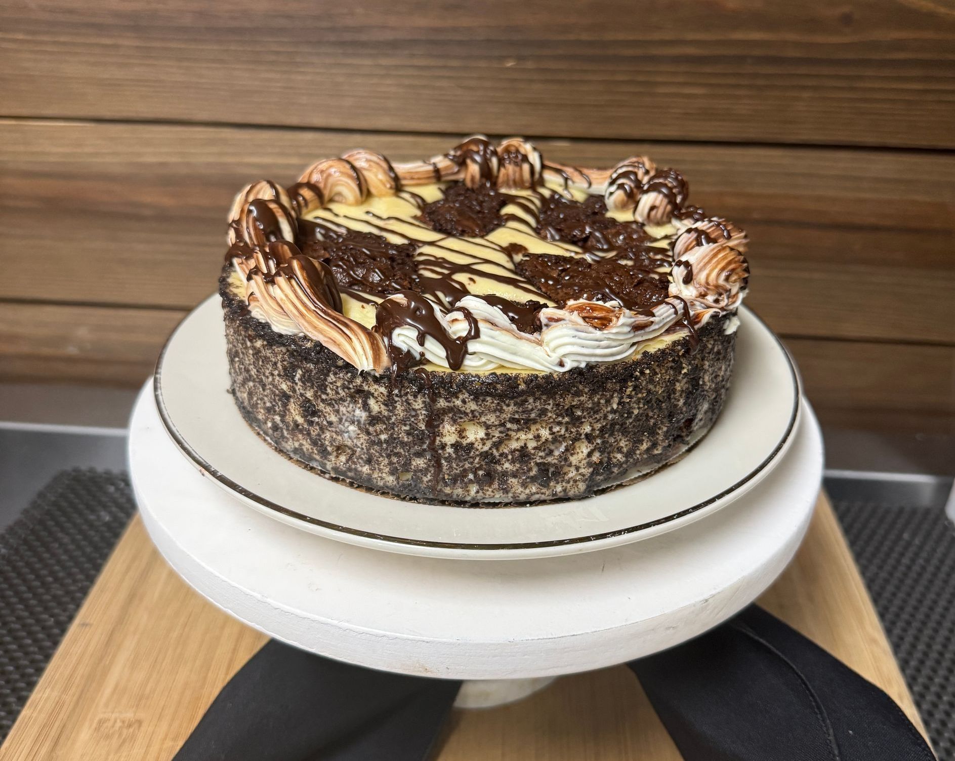 A cake is sitting on a white plate on a table