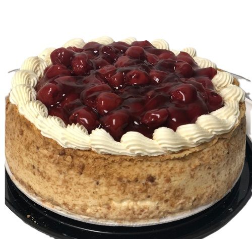 A cheesecake with cherries and whipped cream on top