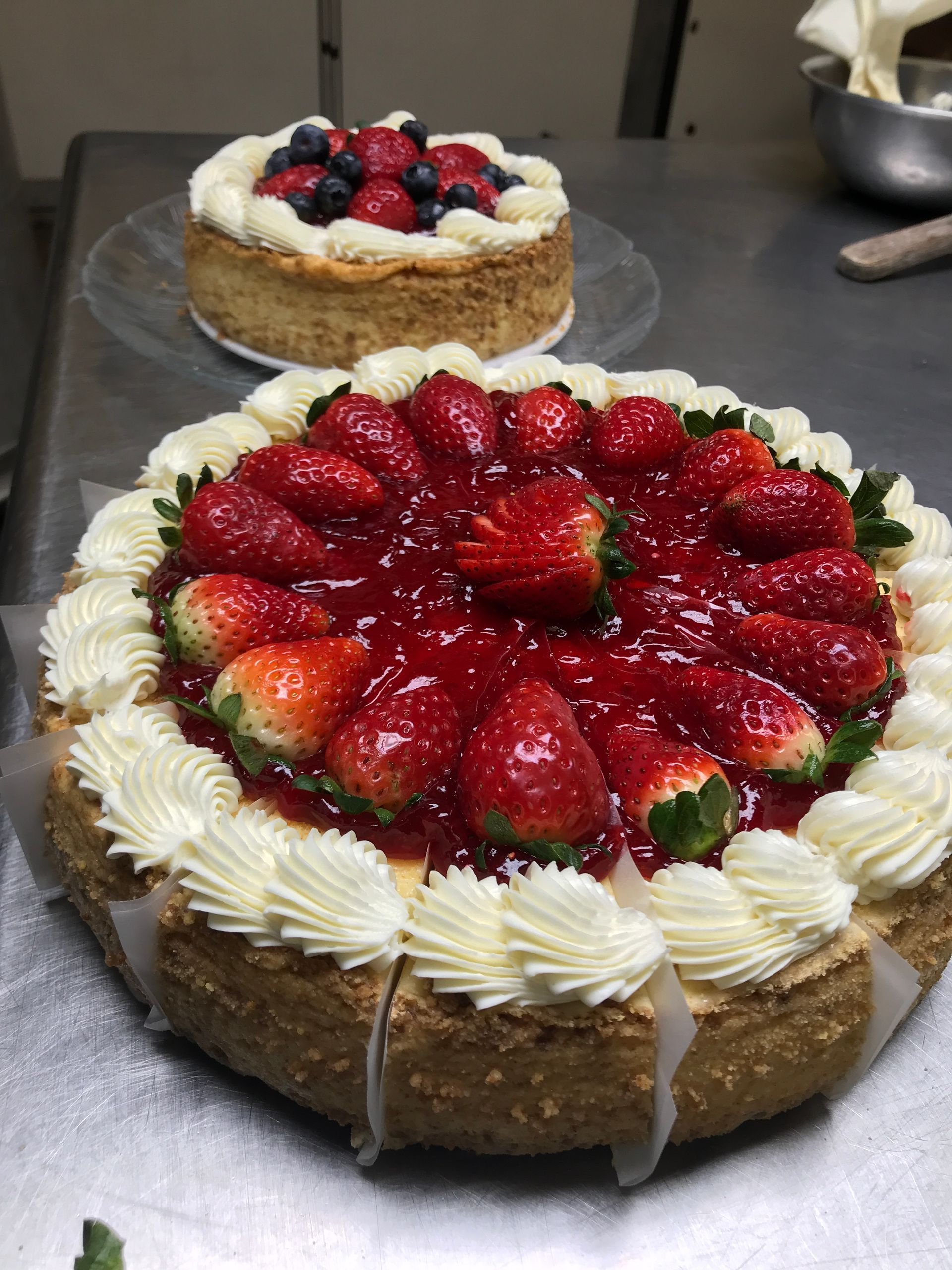 A cheesecake with strawberries and whipped cream on top