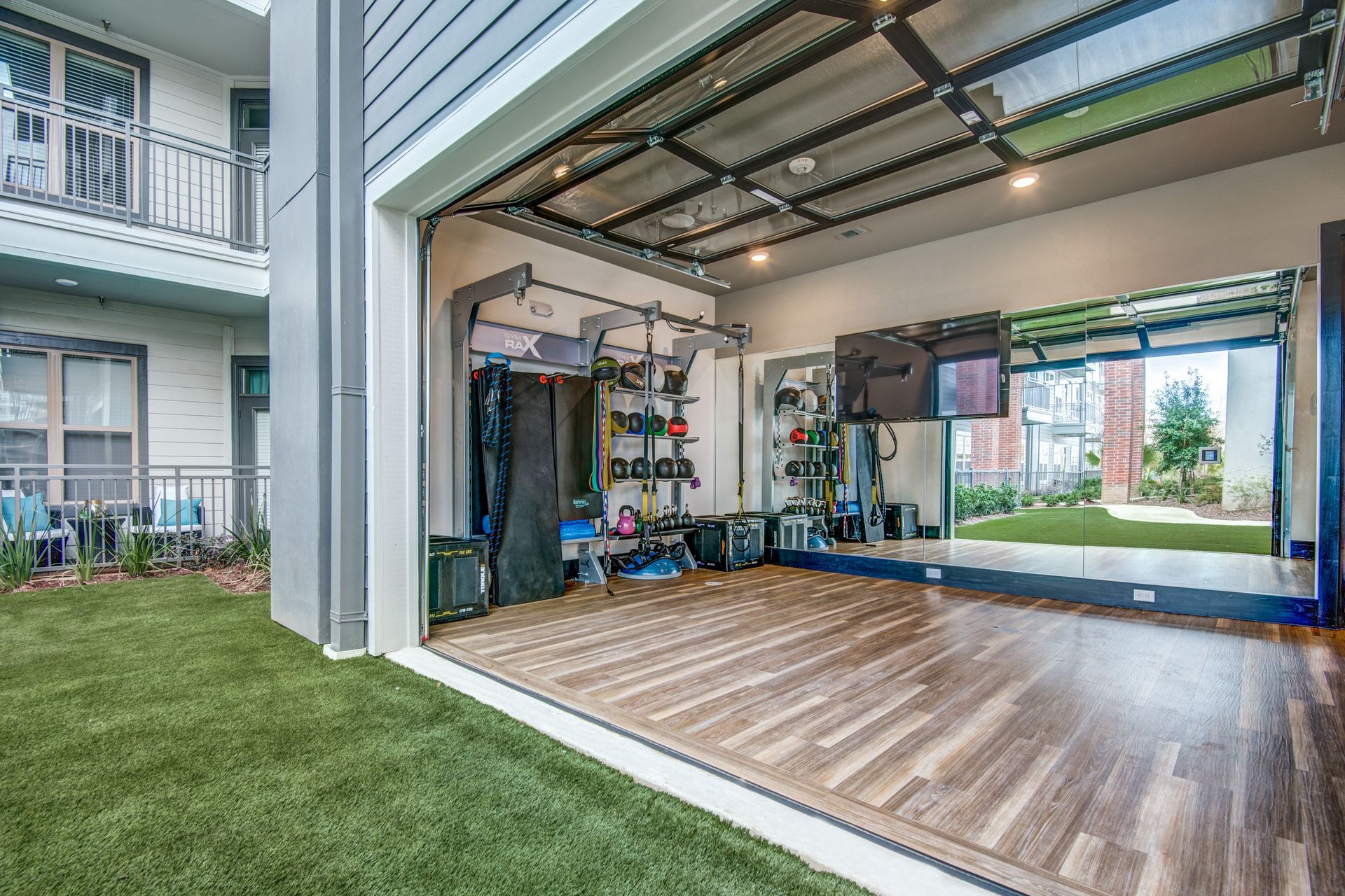 There is a large mirror in the middle of the yoga room at Two99 Monroe offers apartments for rent in Roanoke, TX.