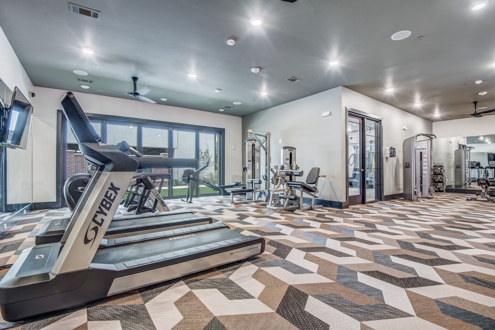 Fitness center with treadmills and machines at Two99 Monroe offers apartments for rent in Roanoke, TX.
