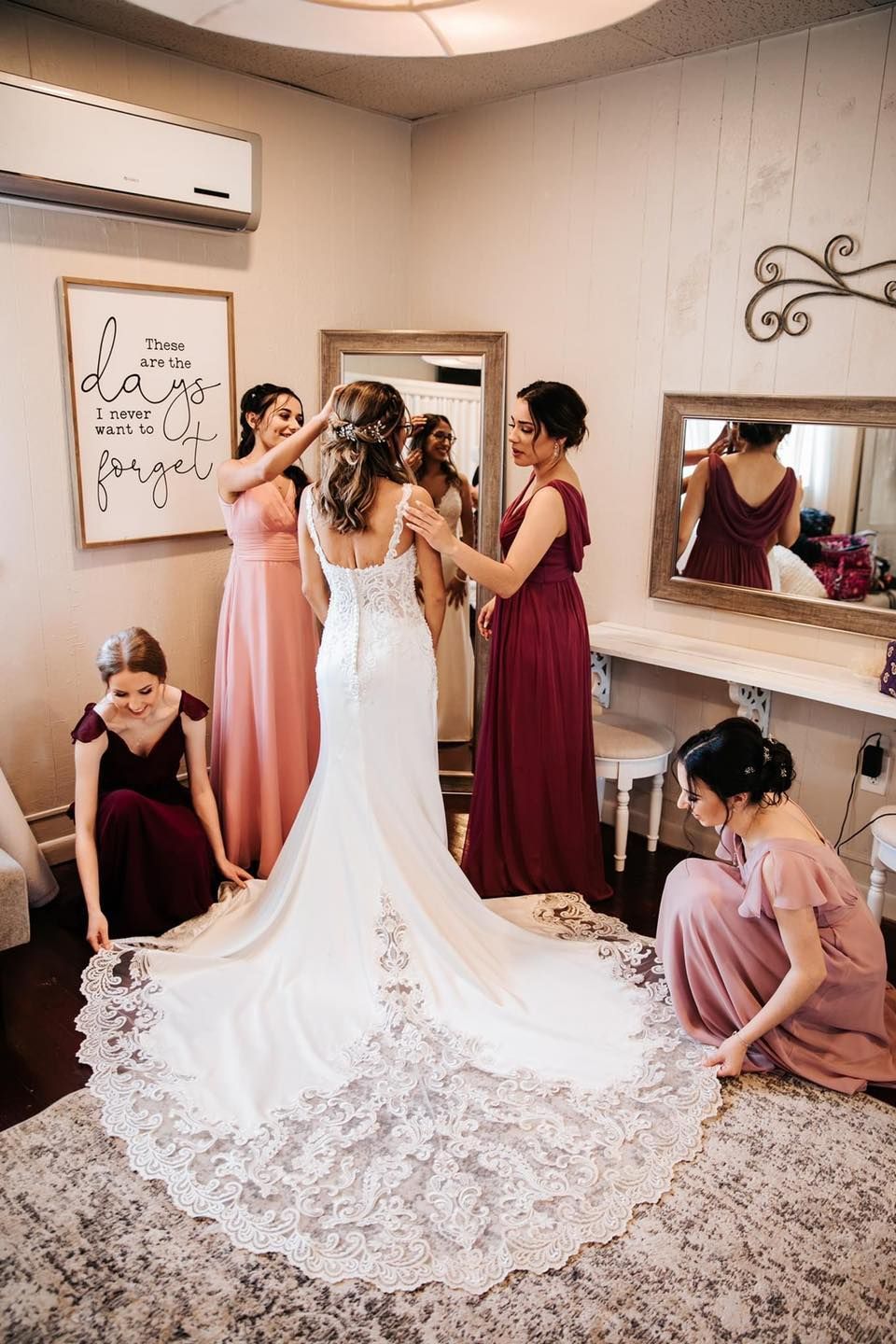 A bride is getting ready for her wedding with her bridesmaids.