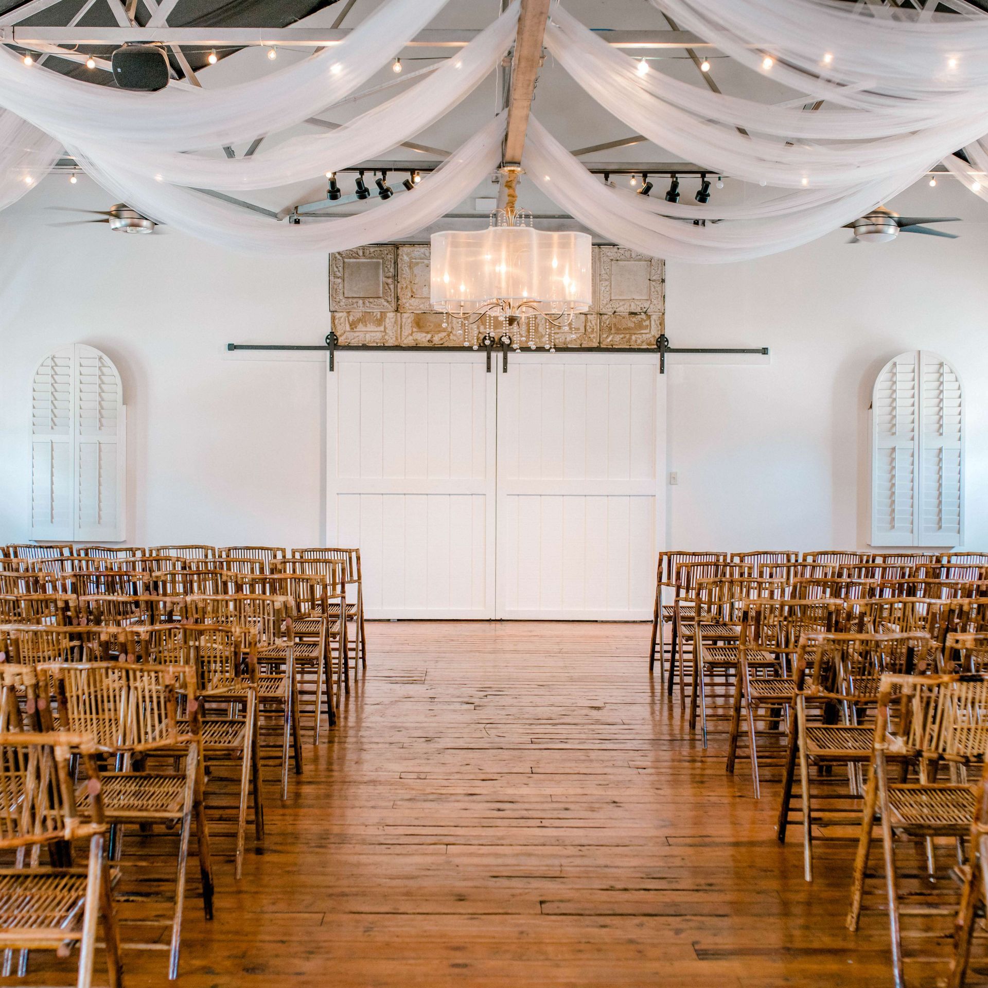 Rows of folding chairs are lined up in a large room