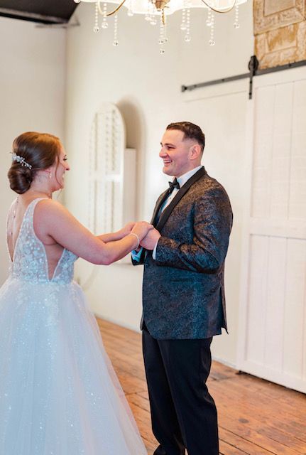 A bride and groom are holding hands in a room.