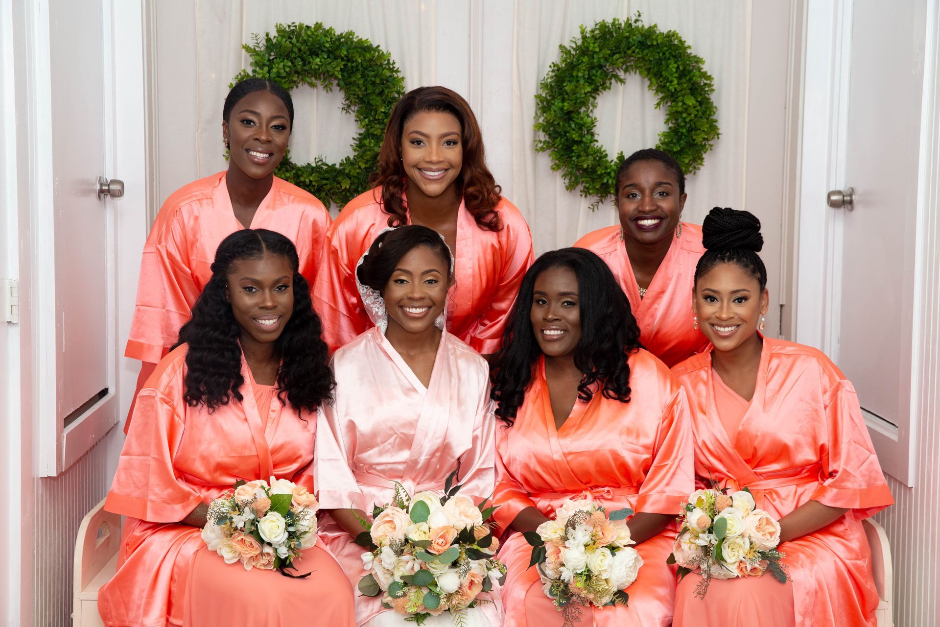 A bride and her bridesmaids are posing for a picture.