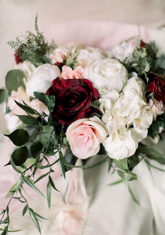 A close up of a bouquet of flowers on a table.
