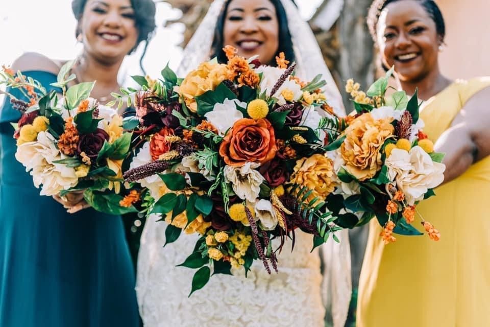 A bride and her bridesmaids are holding bouquets of flowers.