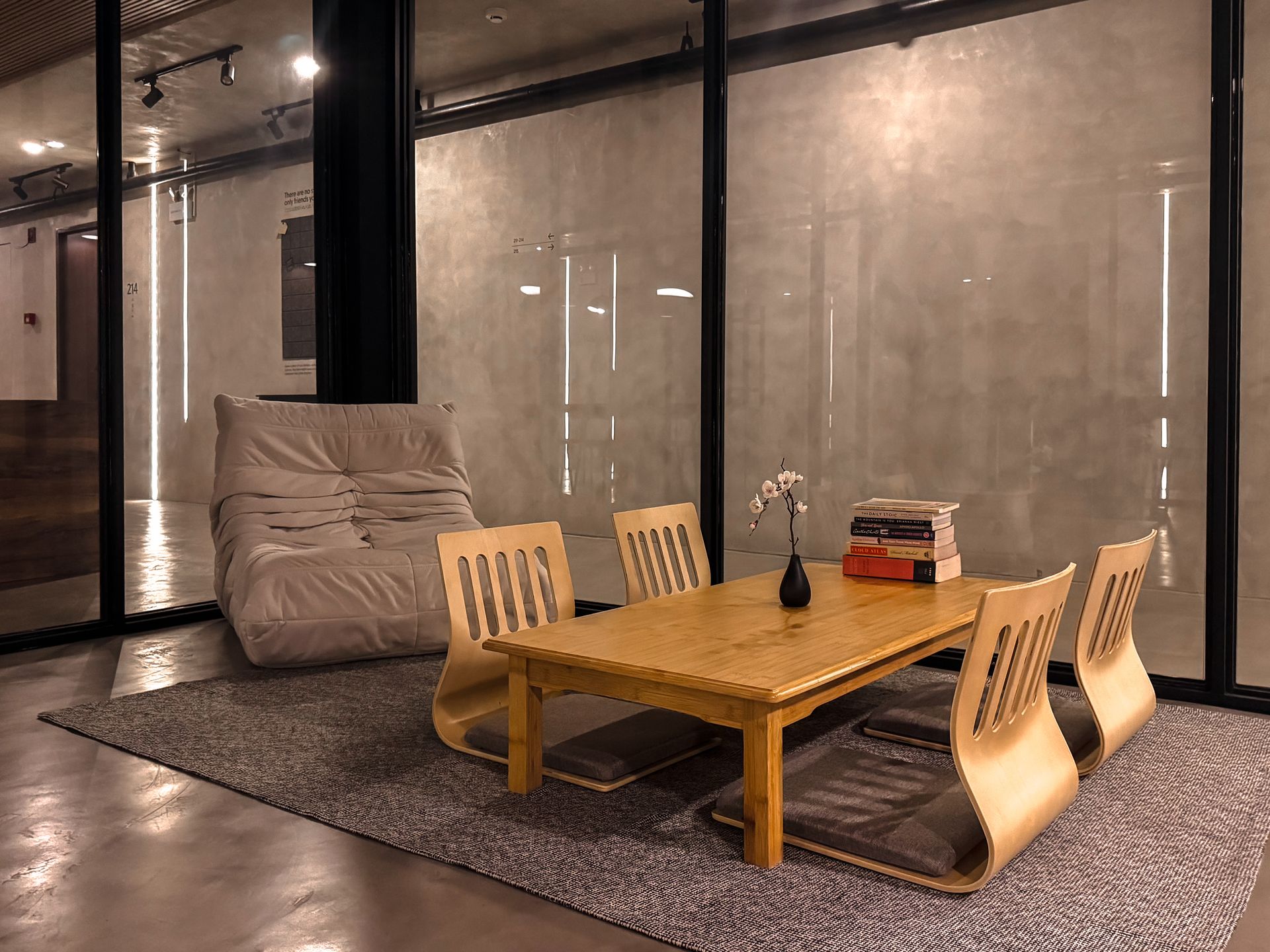 A living room with a table and chairs and a couch.
