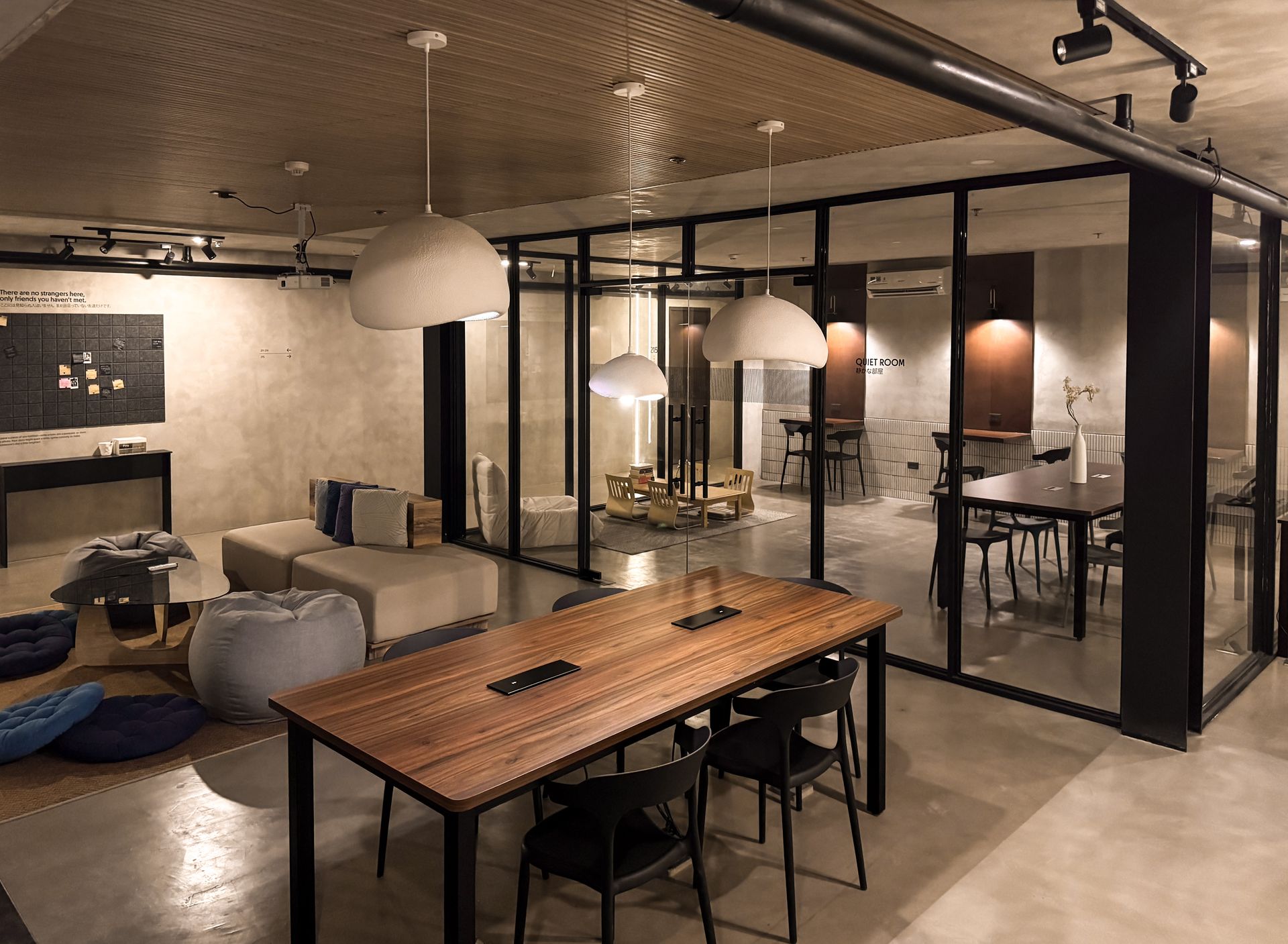 A large room with a wooden table and chairs in it.