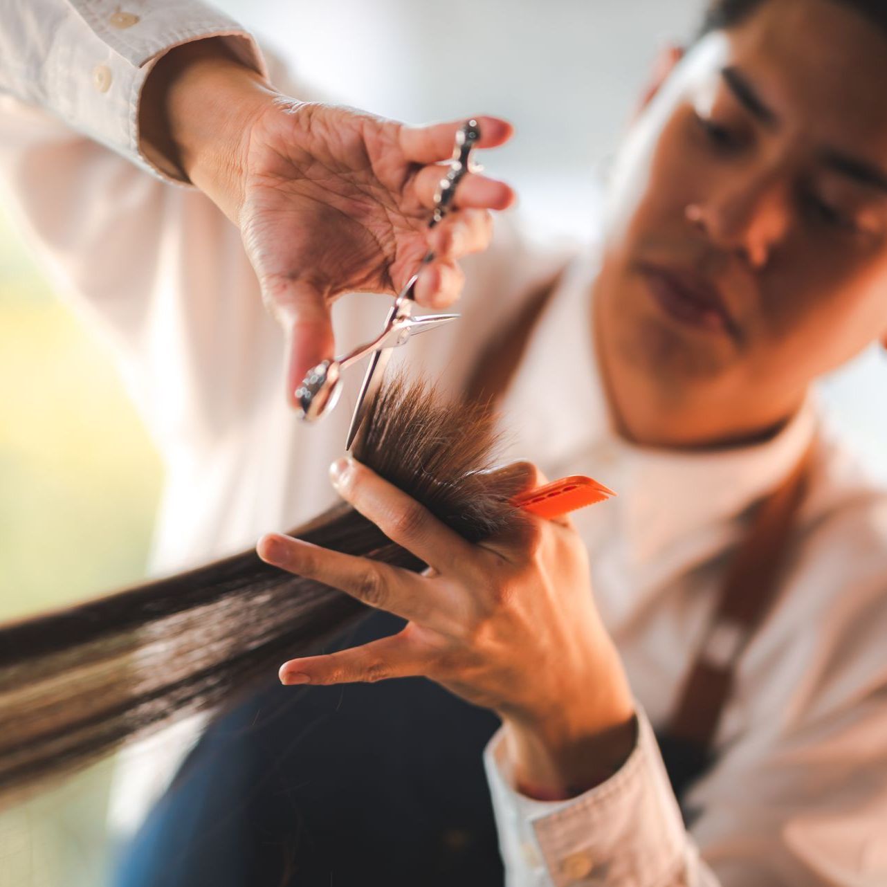 A hairdresser cutting a clients hair