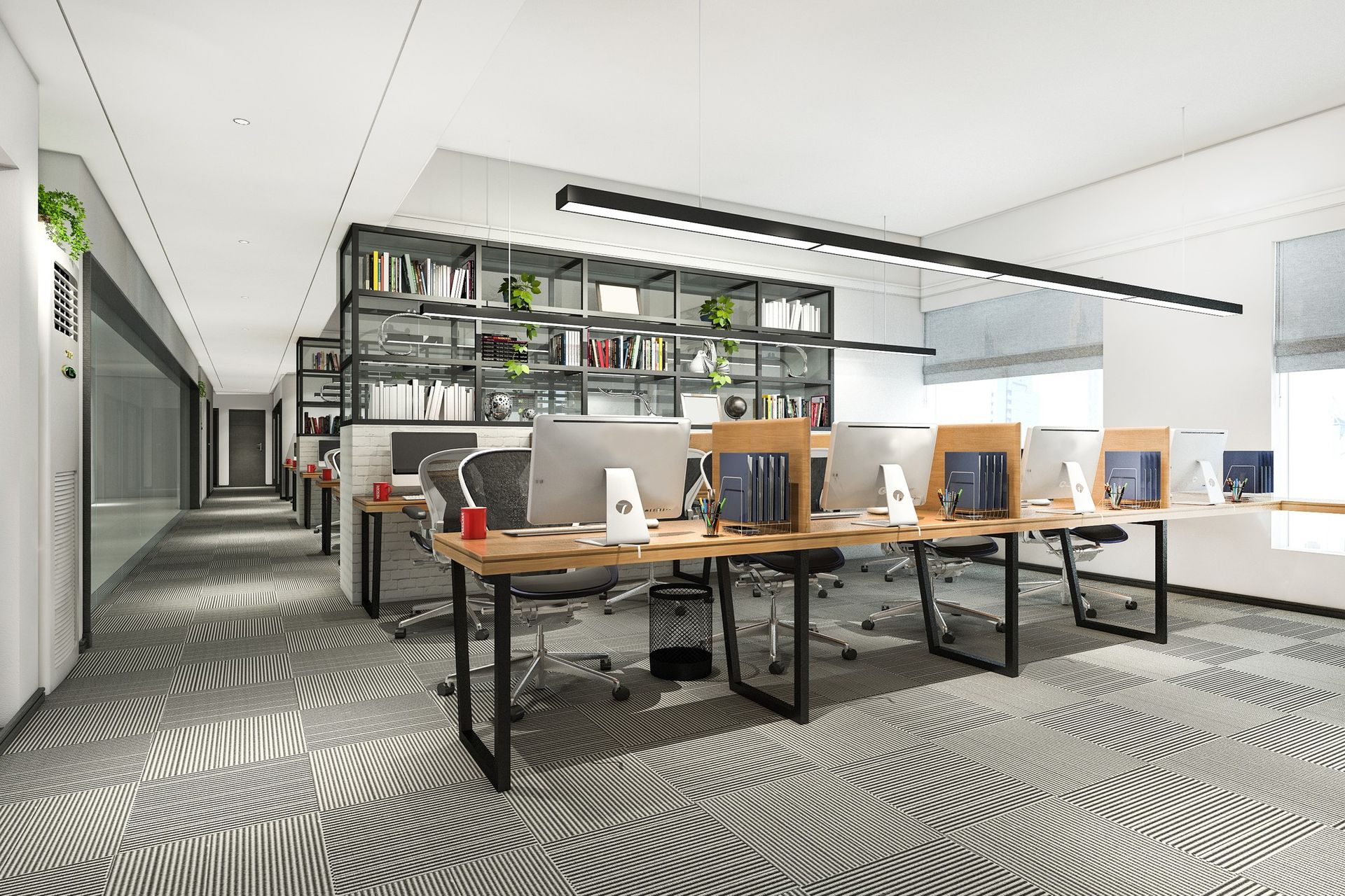 Modern open office with shared desks, shelving, and patterned carpet in a bright workspace
