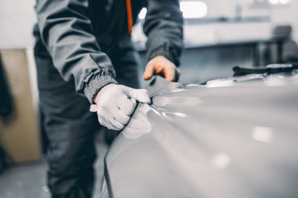Person in Gray Work Suit — Gladstone Mufflers & Suspension In Gladstone Central, QLD