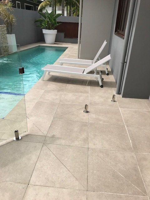 Clean Pool Area Glass Fence— Penguin Pools in Gold Coast, QLD