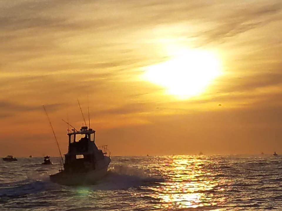 boat in the sea on sun set