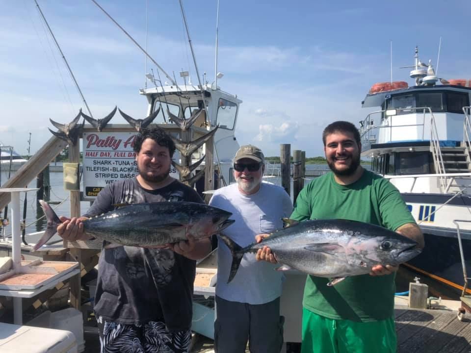 three men showing their catch