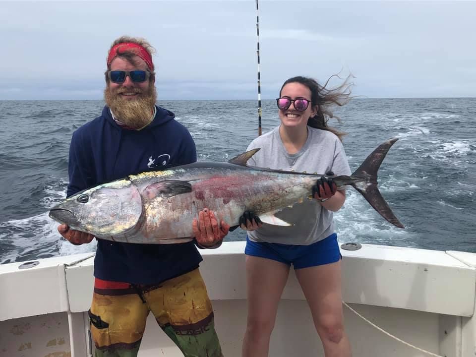 man and woman holding a big fish