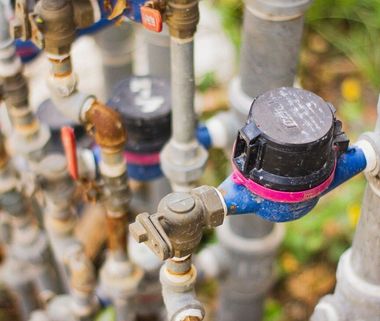 Close-up of colorful water meter pipes and valves in a utility installation