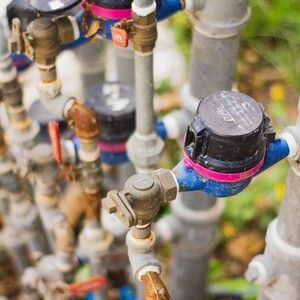 Colorful water meters and pipes in a close-up outdoor utility installation