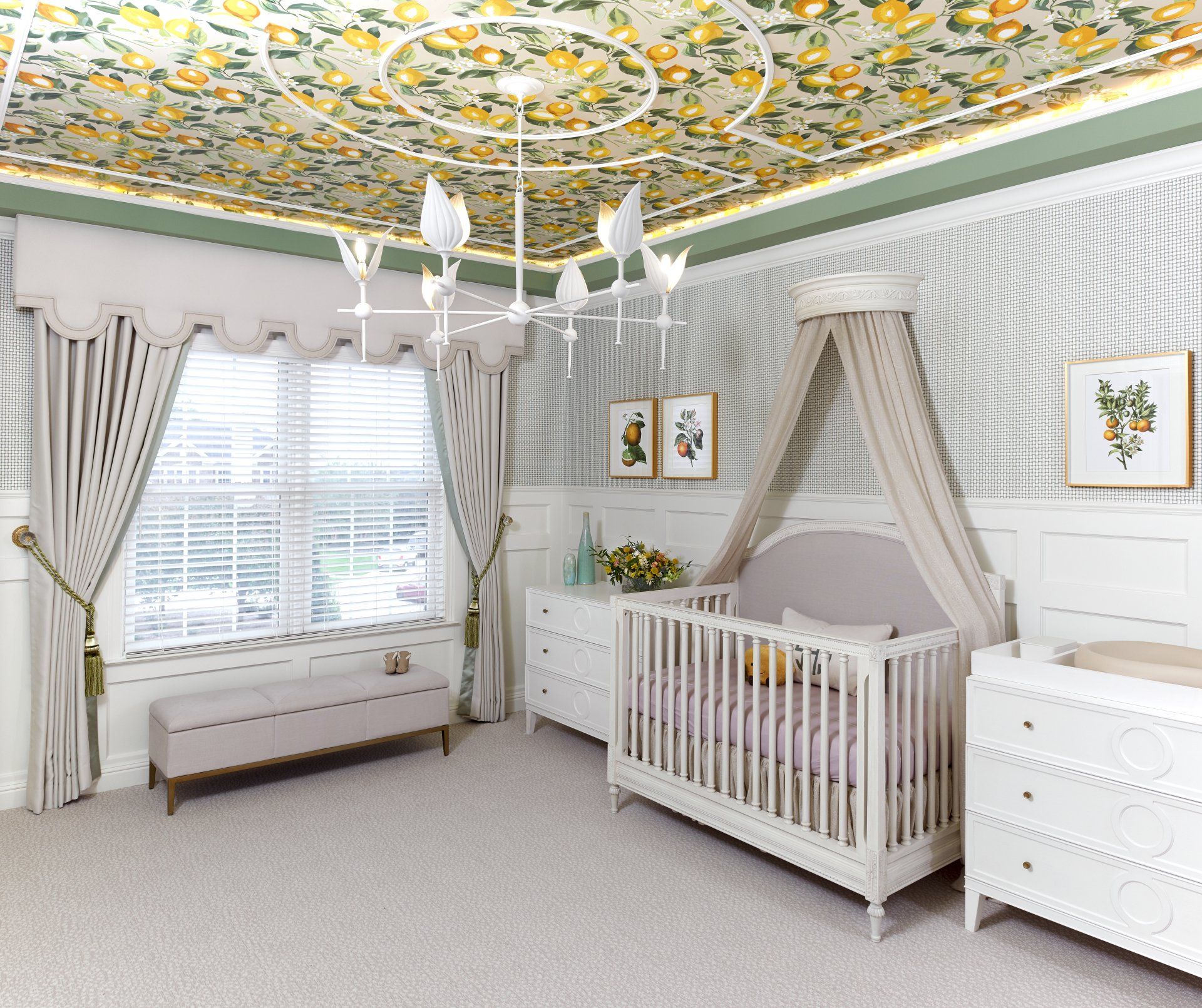 A nursery with a crib , dresser , bench and window.