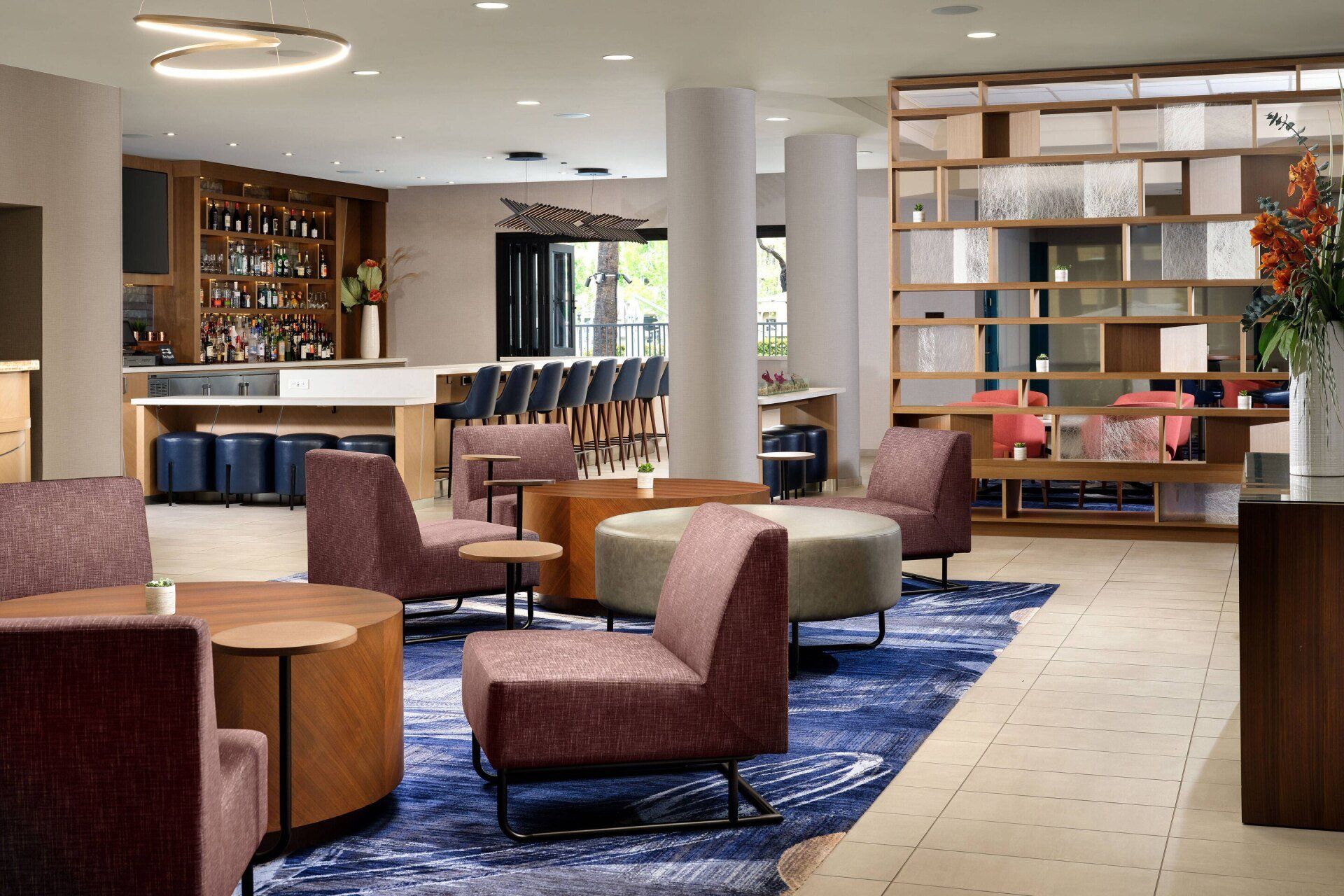 A hotel lobby with tables and chairs and a bar