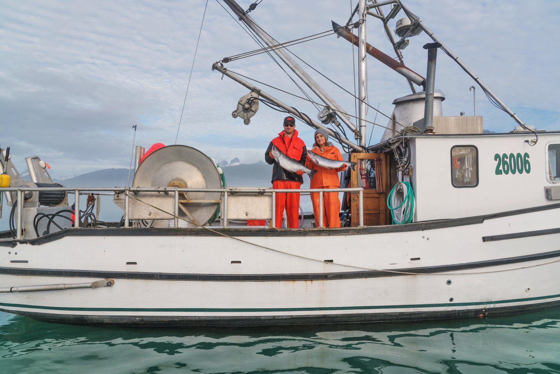 Peter and Chelsea Keutmann on the F/V Eric holding 2 fish