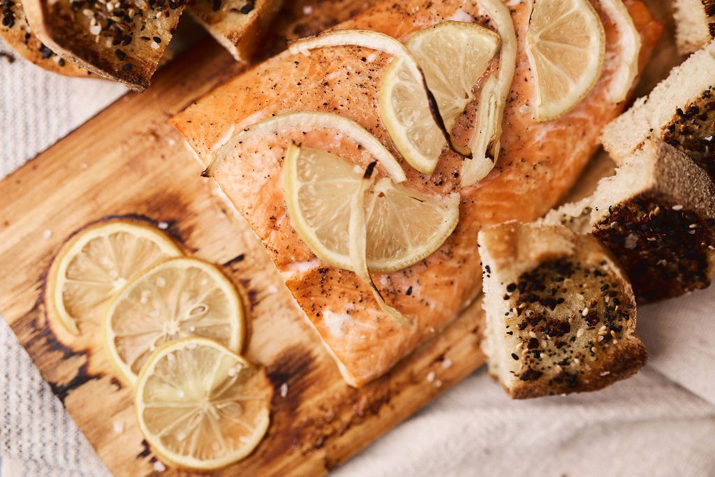 cooked salmon filet with lemons and seasonings