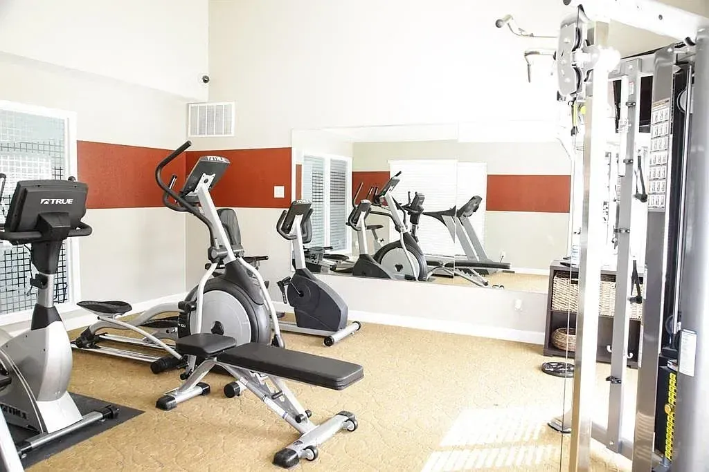 Fitness center with cardio machines and weight equipment.