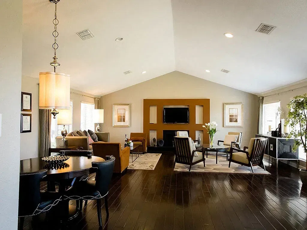 Spacious living room and dining area with hardwood floors and a fireplace.