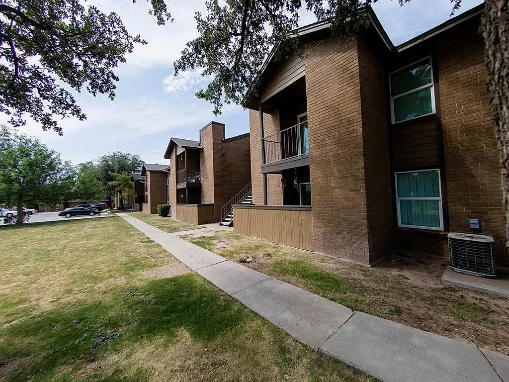 Exterior of brick apartment buildings with balconies and walkways.