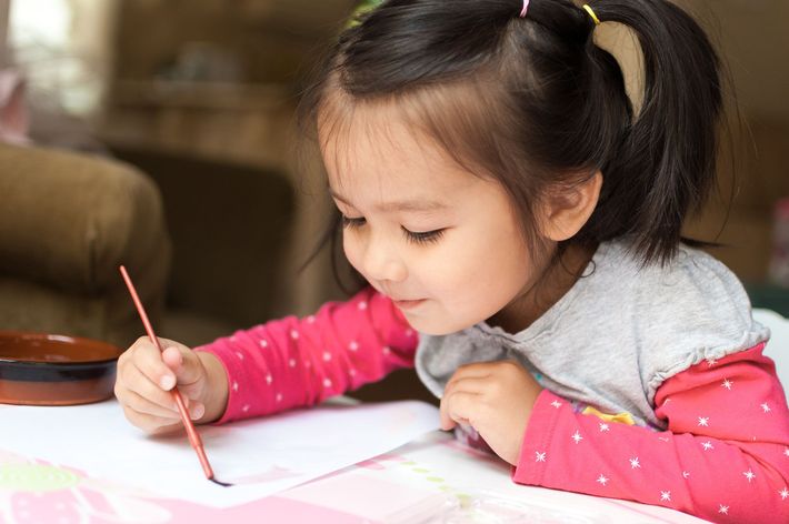 Girl painting on paper