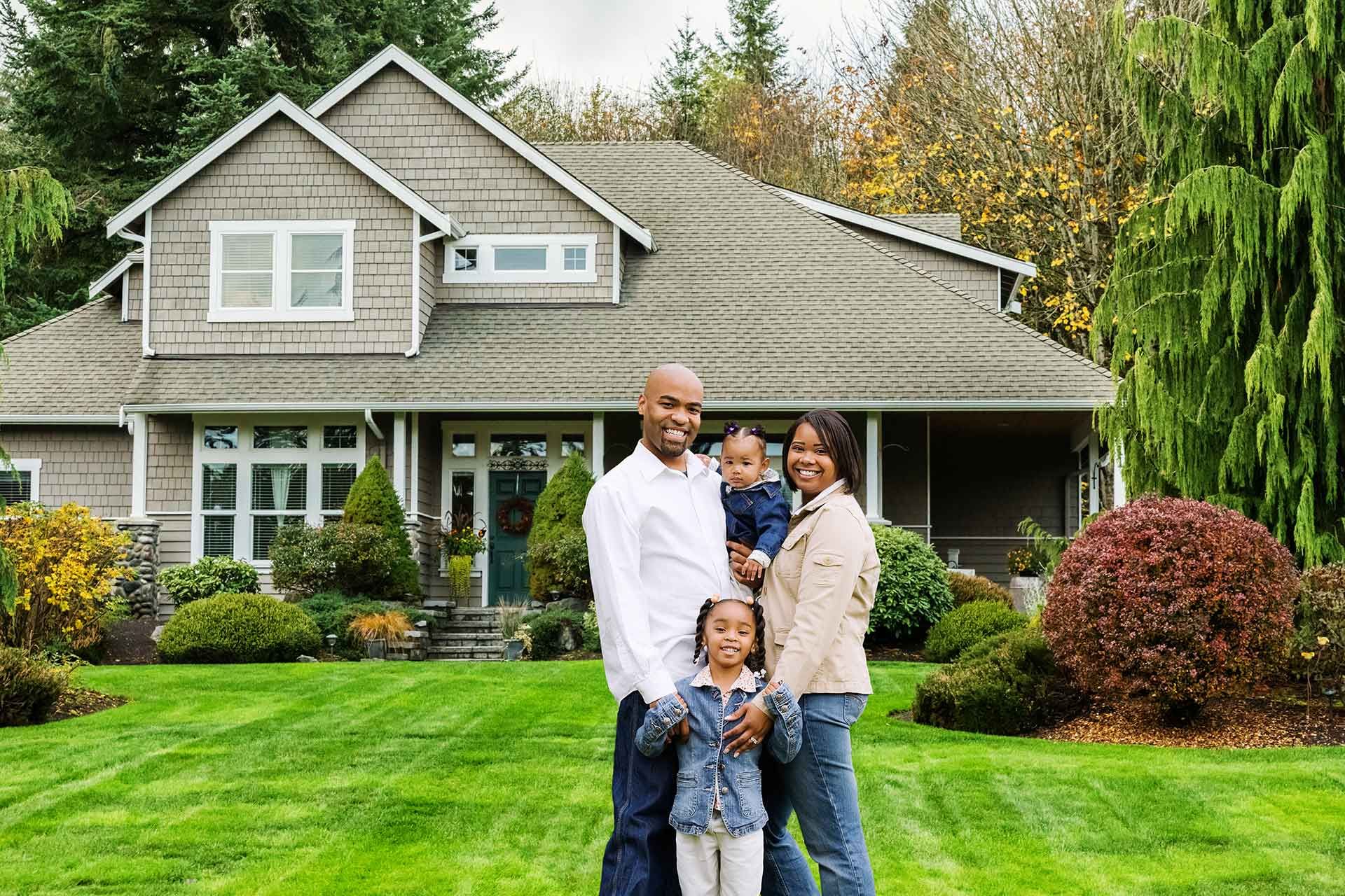 A family standing in front of their suburban home – Dayton, OH - C & G Mortgage