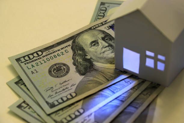 American hundred-dollar bills and illuminated paper house – Dayton, OH - C & G Mortgage