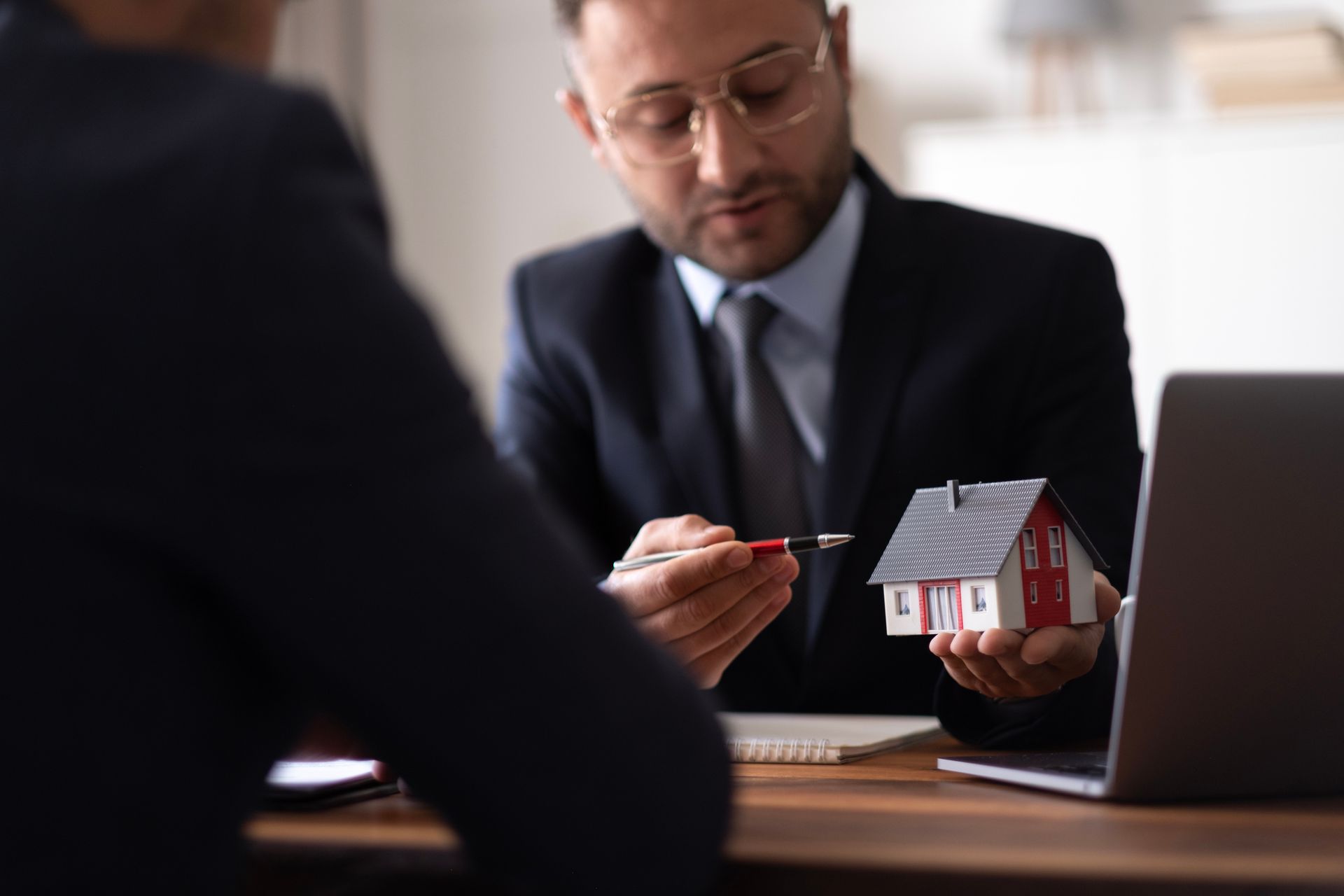 Male client holding pen to reading agreement document – Dayton, OH - C & G Mortgage Male client holding pen to reading agreement document – Dayton, OH - C & G Mortgage