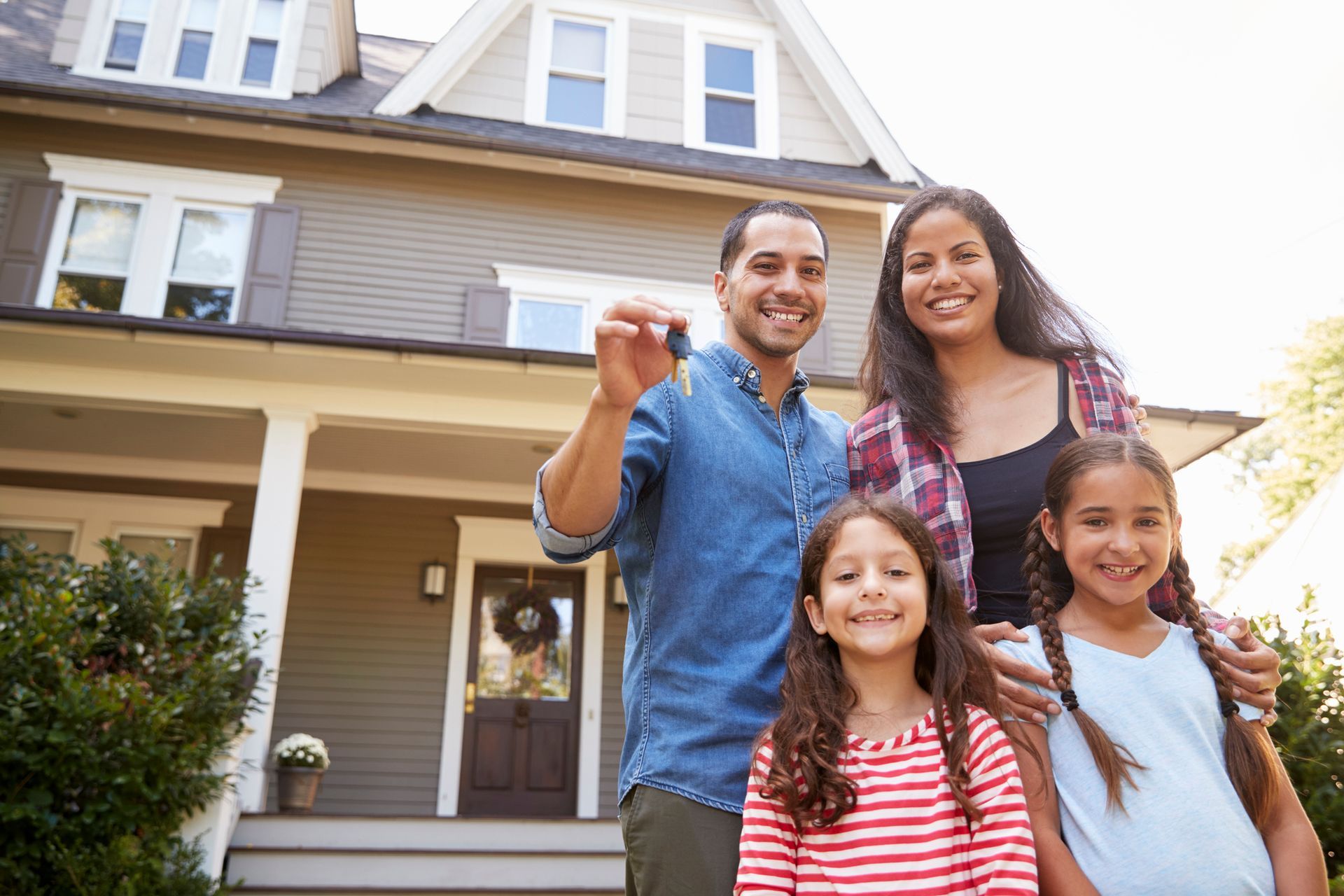 Family holding keys to new home on moving in day – Dayton, OH - C & G Mortgage