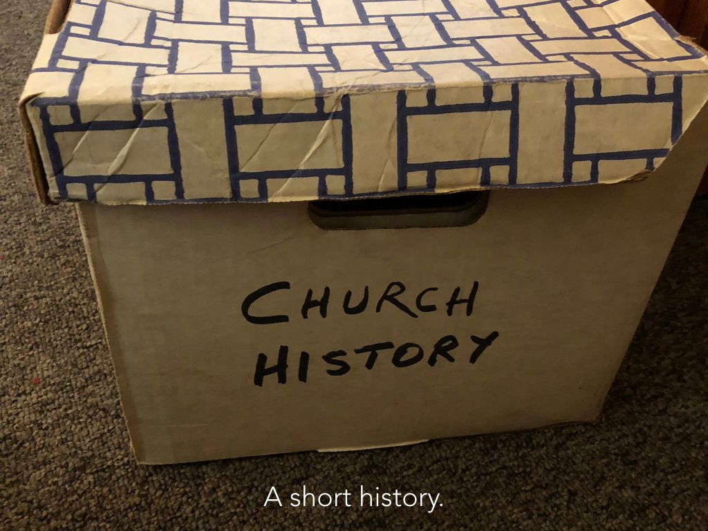 A cardboard box that says church history on it