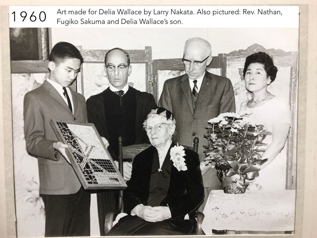 A black and white photo of a group of people in 1960.