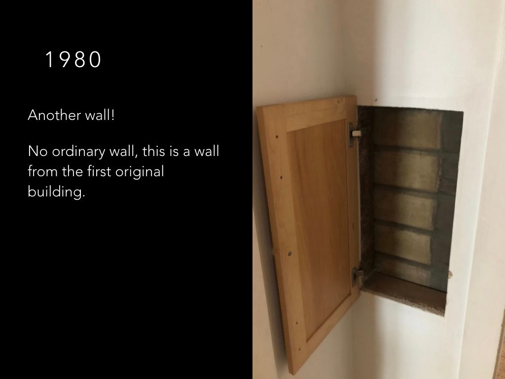 A picture of a wall with a wooden cabinet in it