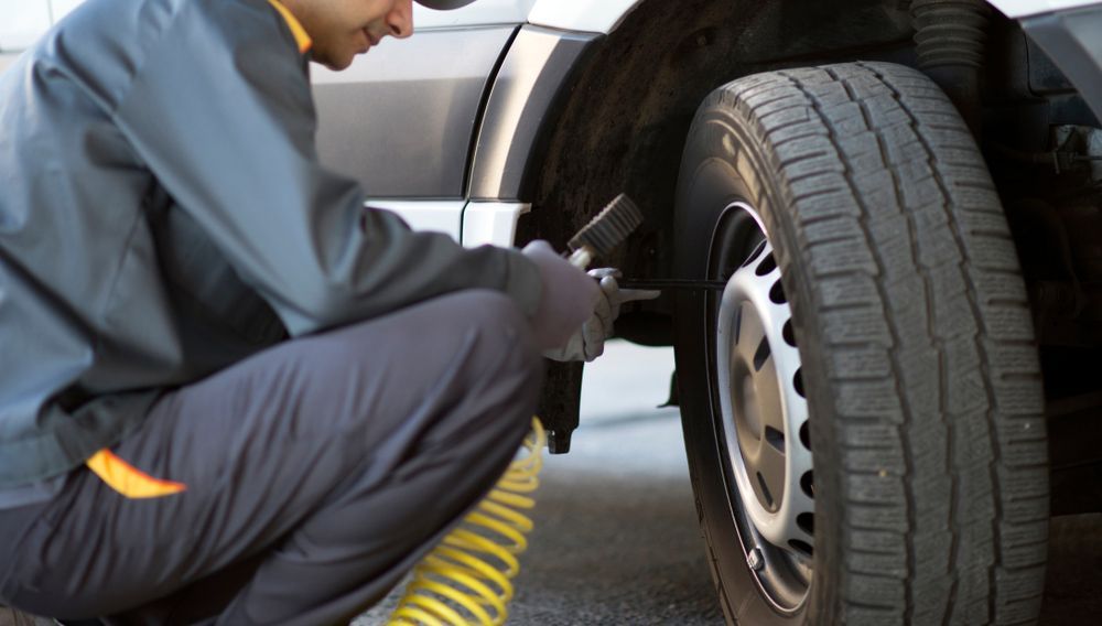 Mechanic Checking the Pressure of A Tyre