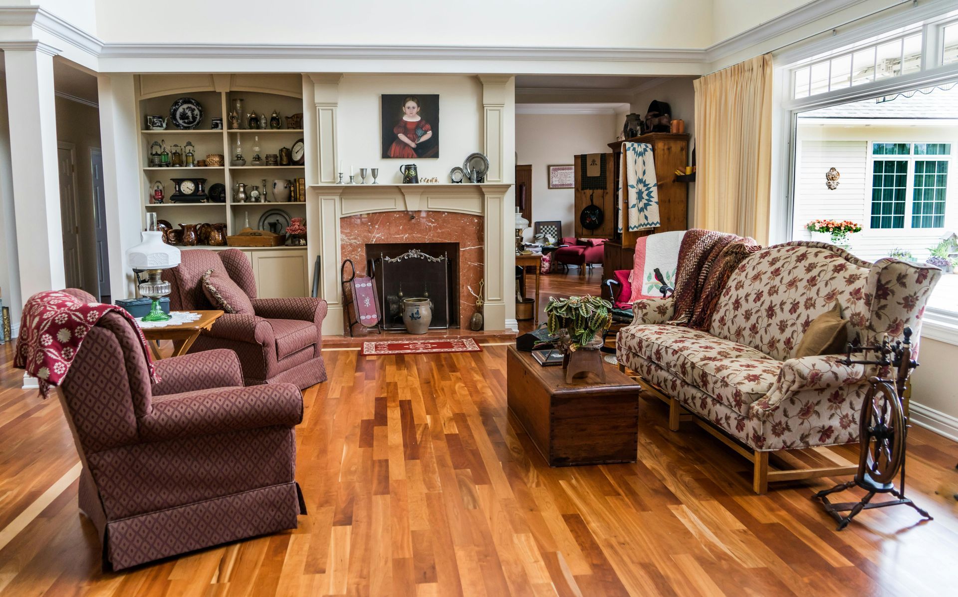 A living room with a couch , chairs , coffee table and fireplace.