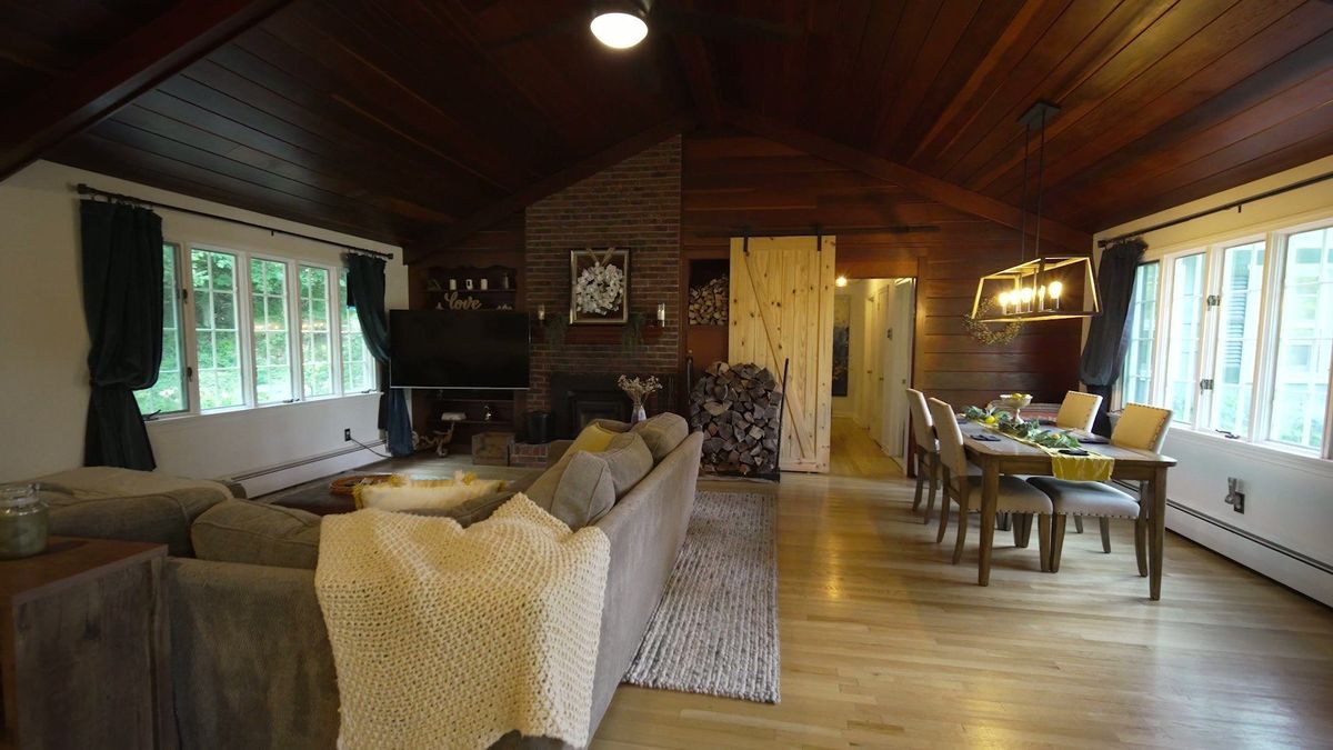 Living and dining spaces beneath the wood ceiling