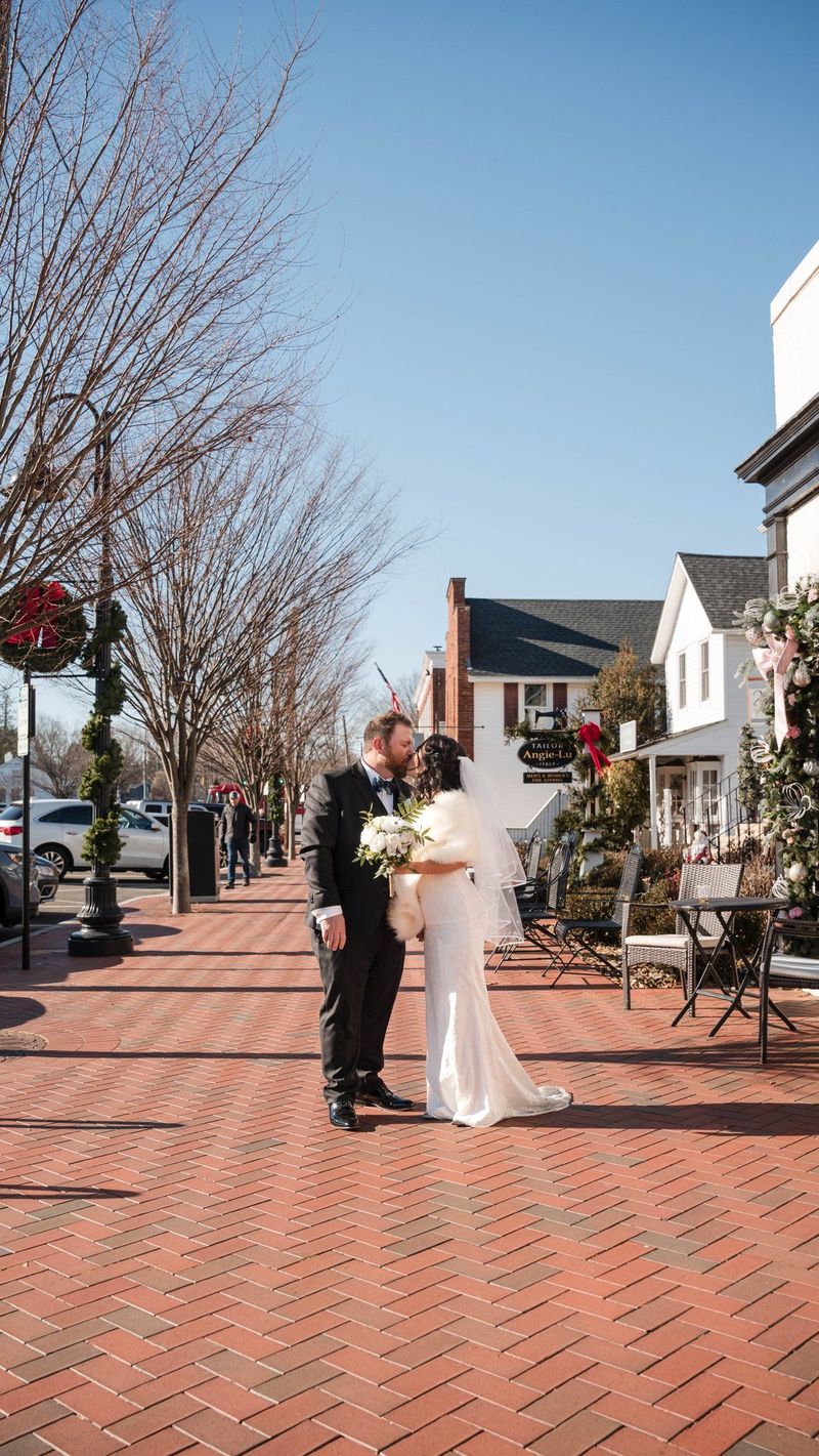 A wide portrait places Amanda and Charles along a brick sidewalk