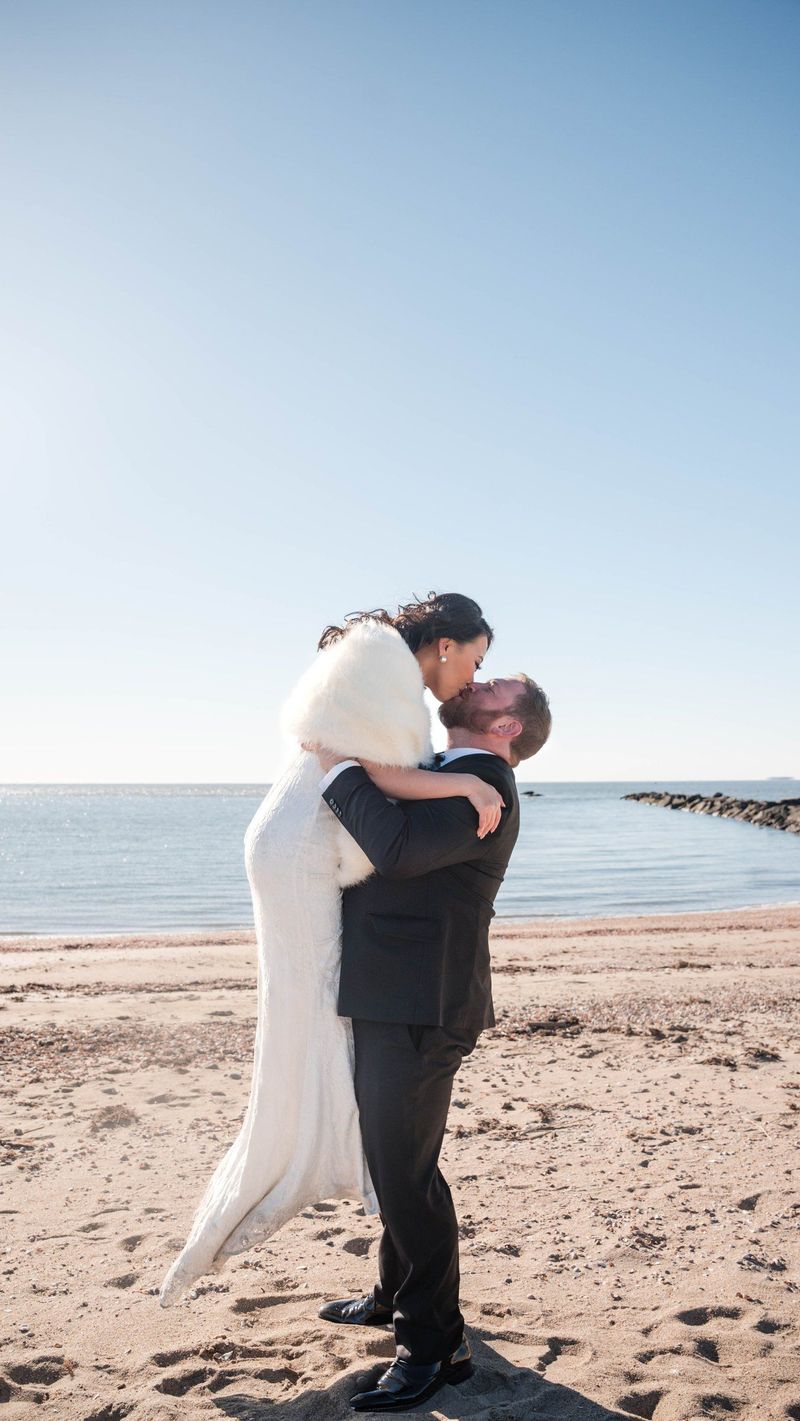 Charles lifts Amanda in an embrace on the sand