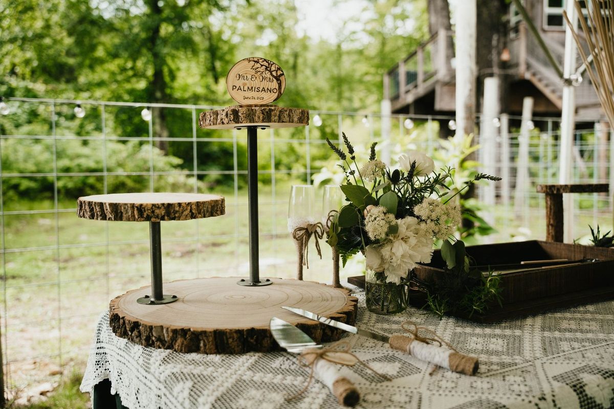 Wood-slice dessert stands, flowers and a personalized cake topper