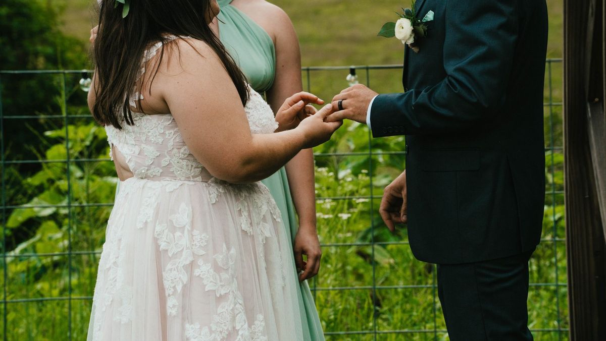 Ashley places a ring on Anthony’s hand