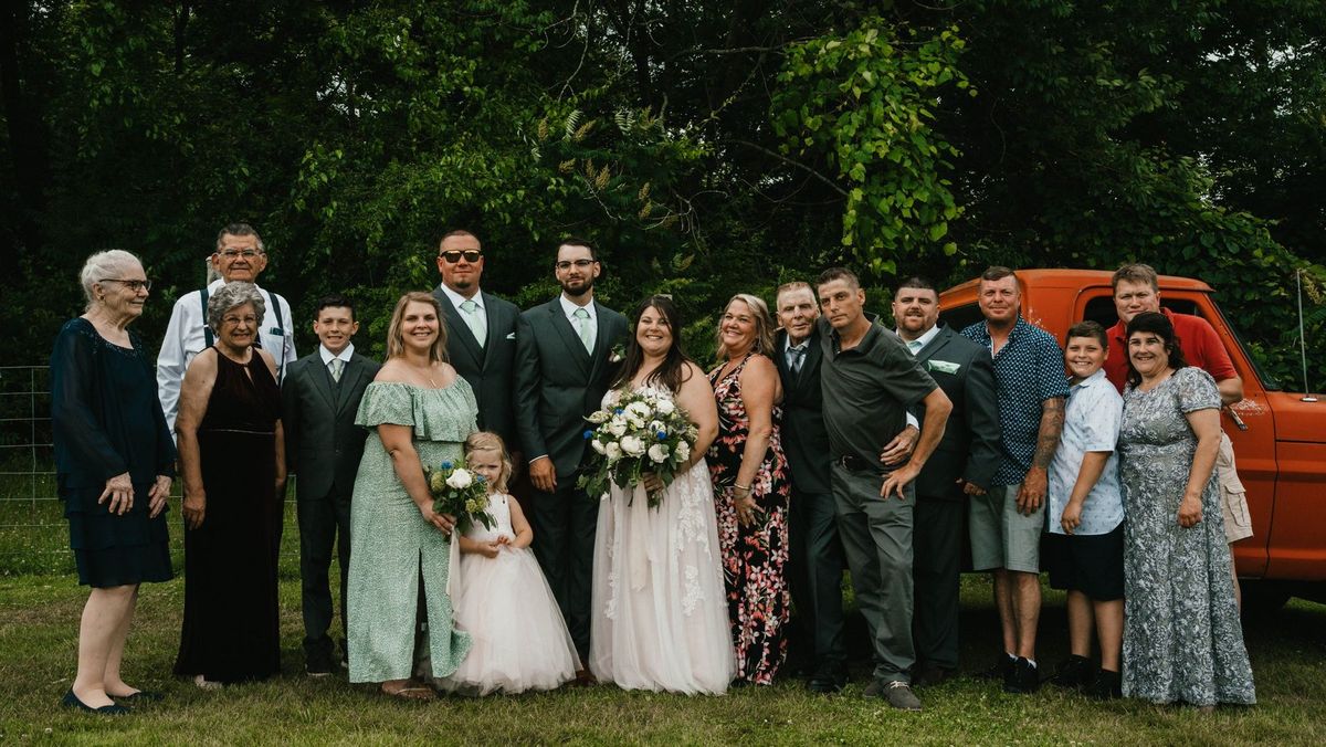 Ashley and Anthony with a larger group of loved ones outdoors